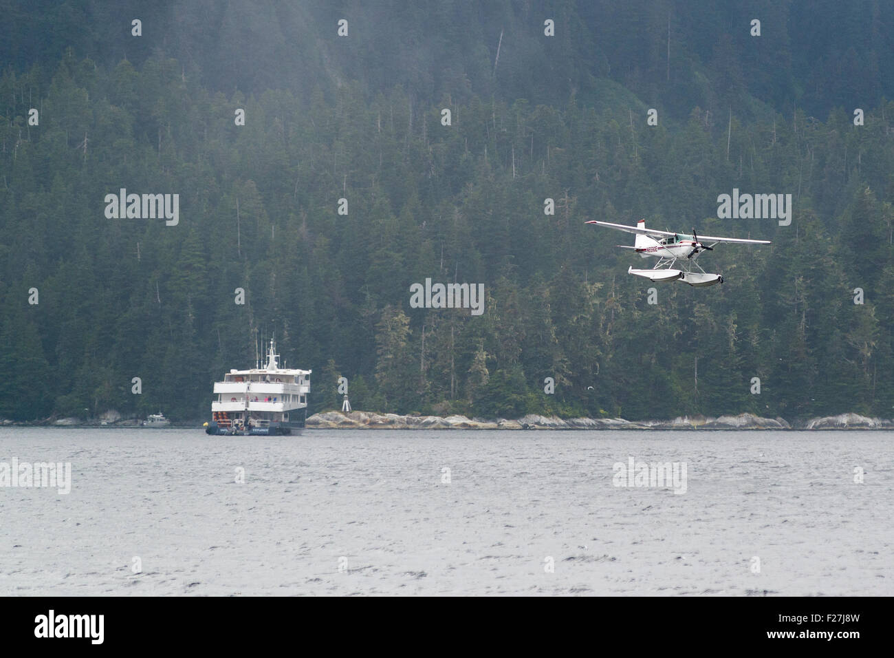 Float plane and boats at Hidden Falls, Southeast Alaska. Stock Photo