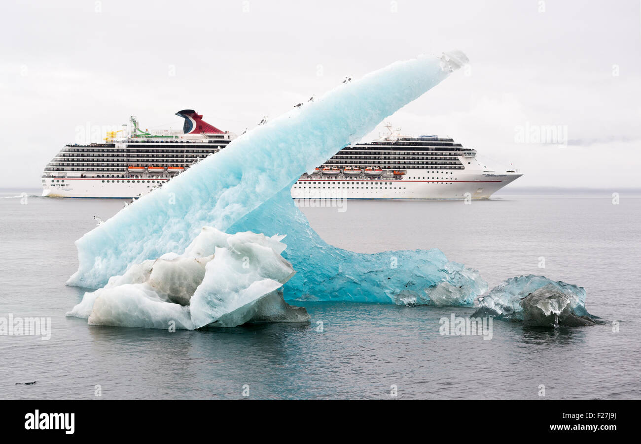 Carnival Legend cruise ship and an iceberg with gulls in Stephen's Passage, Alaska. Stock Photo