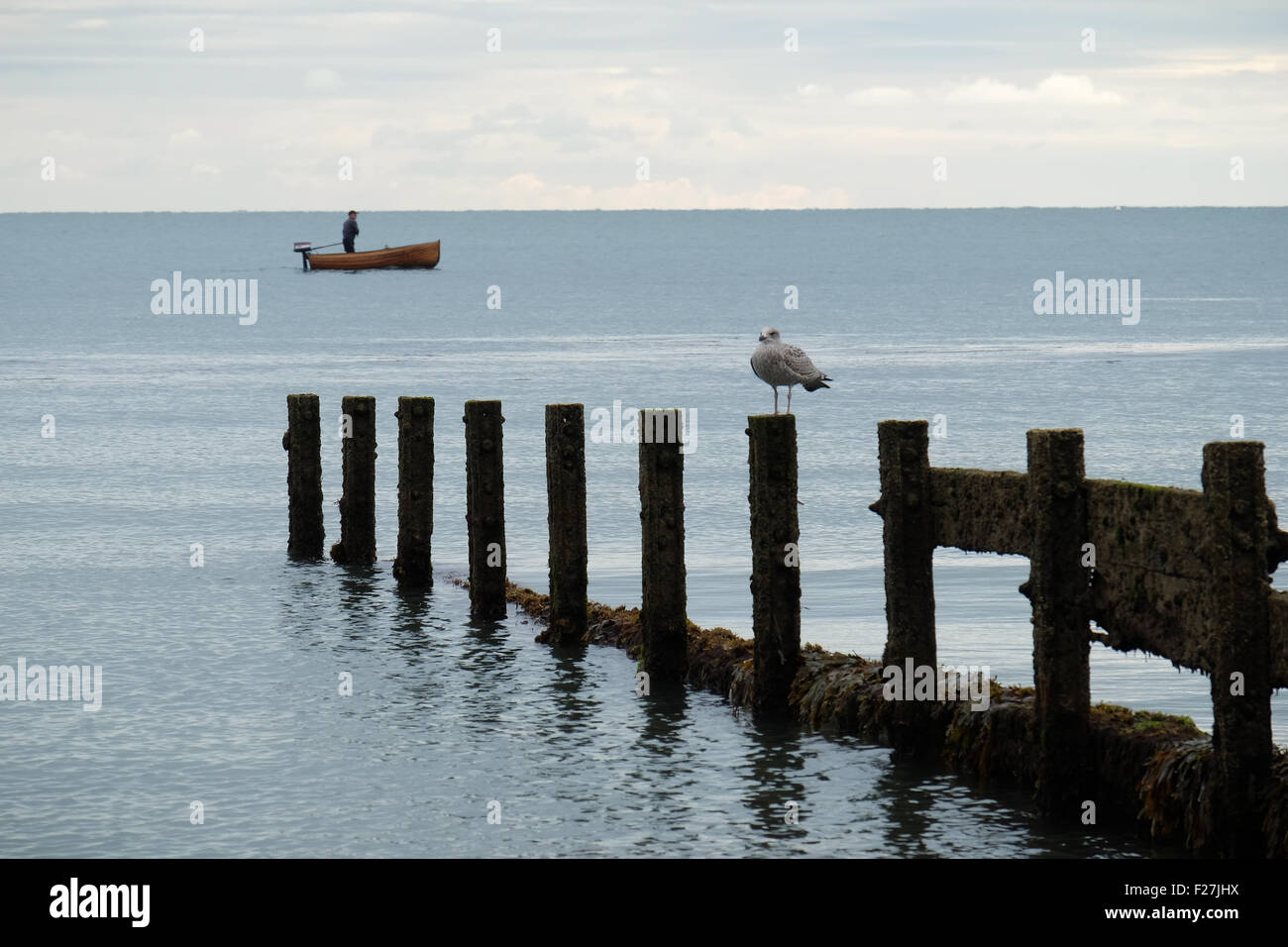 A man in his fishing dinghy in Sandown Bay, Isle of Wight, England Stock Photo
