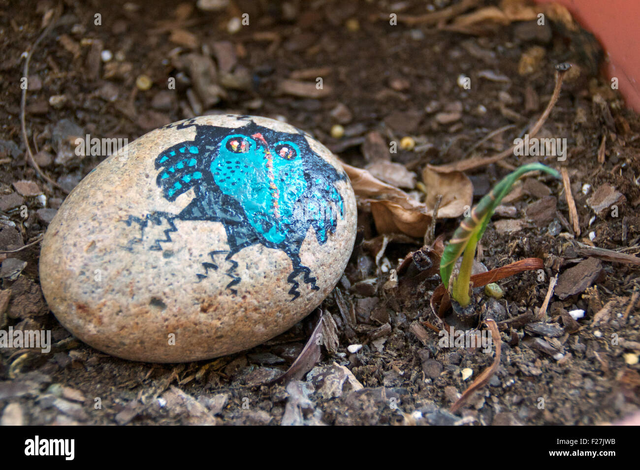 A painted stone in a flower pot. Stock Photo
