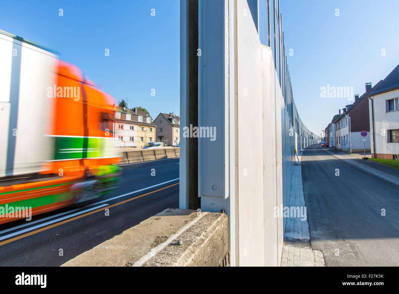 High noise barrier along A40 Autobahn, motorway, in Essen Germany, private houses standing just 10 Meters away from the lane Stock Photo