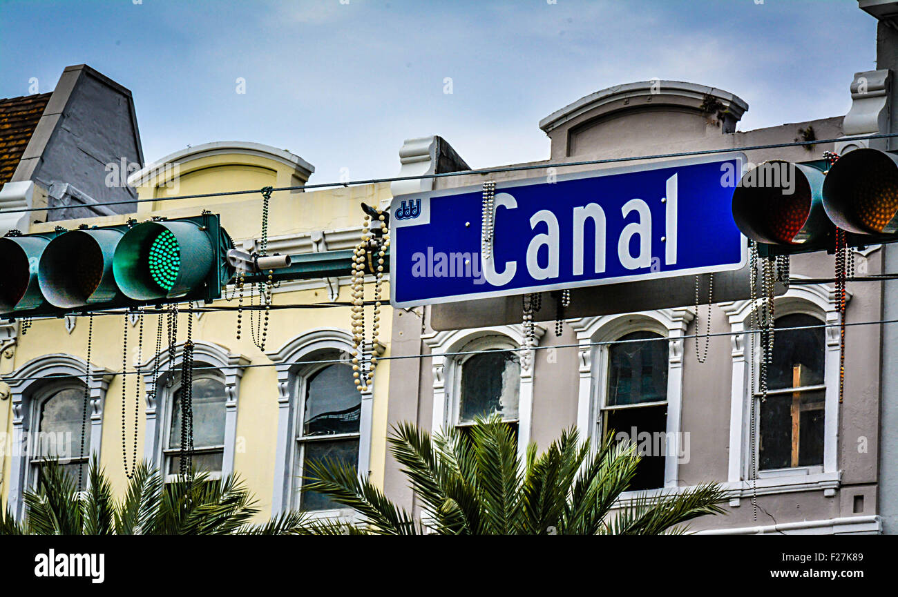 Madri Gras beads hang from Canal Street overhead street sign with traffic lights and classic New Orleans architecture Stock Photo