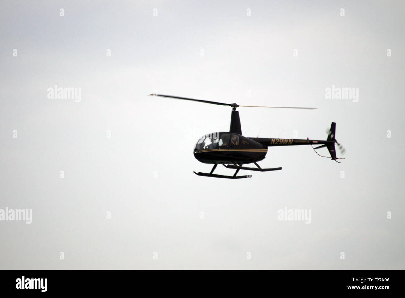 A tour helicopter flying over a beach in Florida Stock Photo