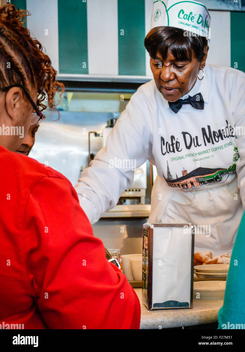 Waitress serving and coffee at the famous Café du Monde in the
