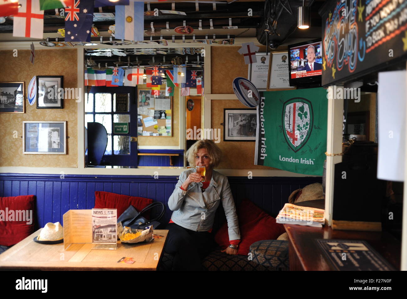 Godalming Surrey UK - Woman drinking in The Star pub Stock Photo