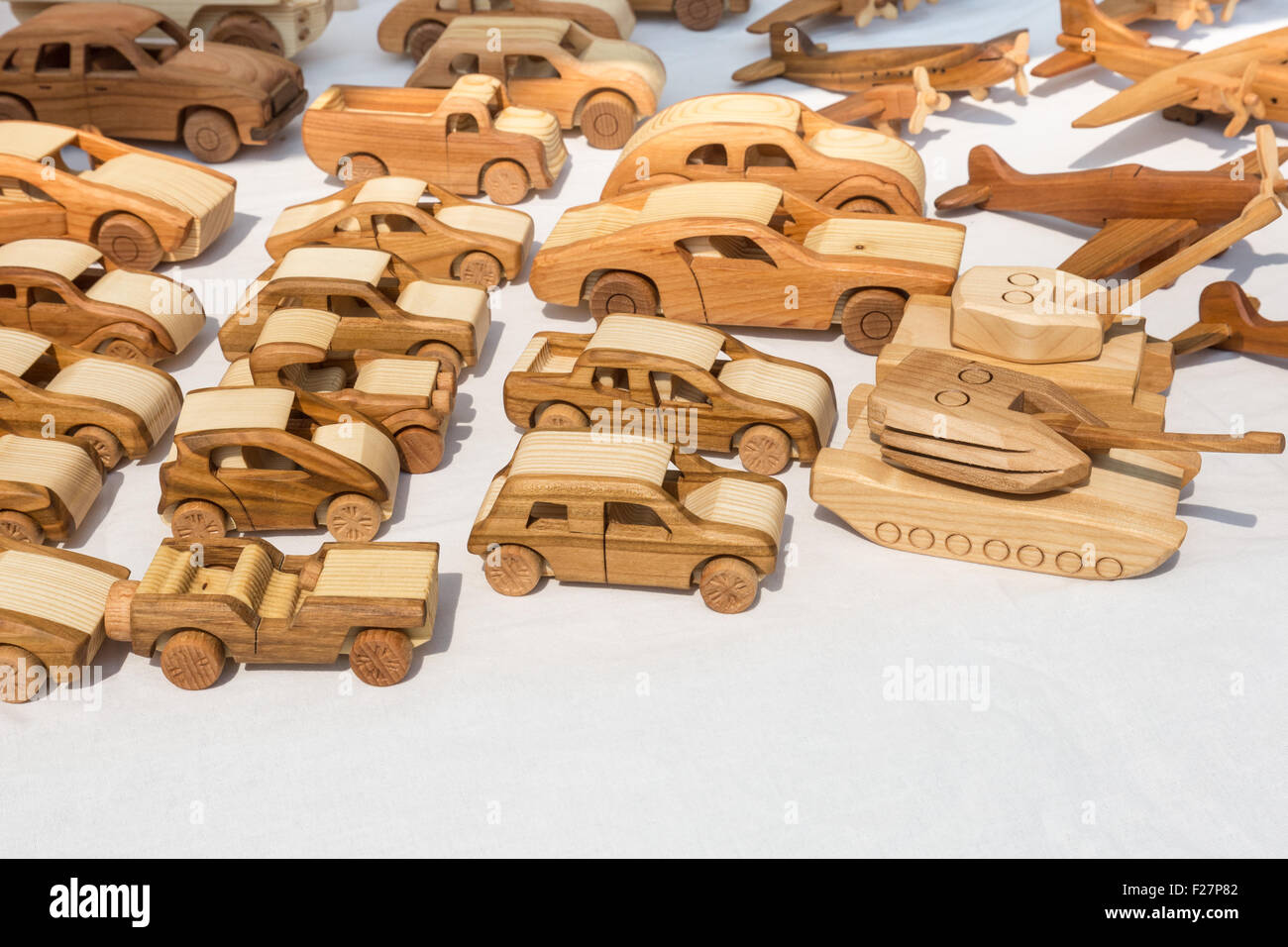 a selection of wooden toy cars, tanks and planes Stock Photo