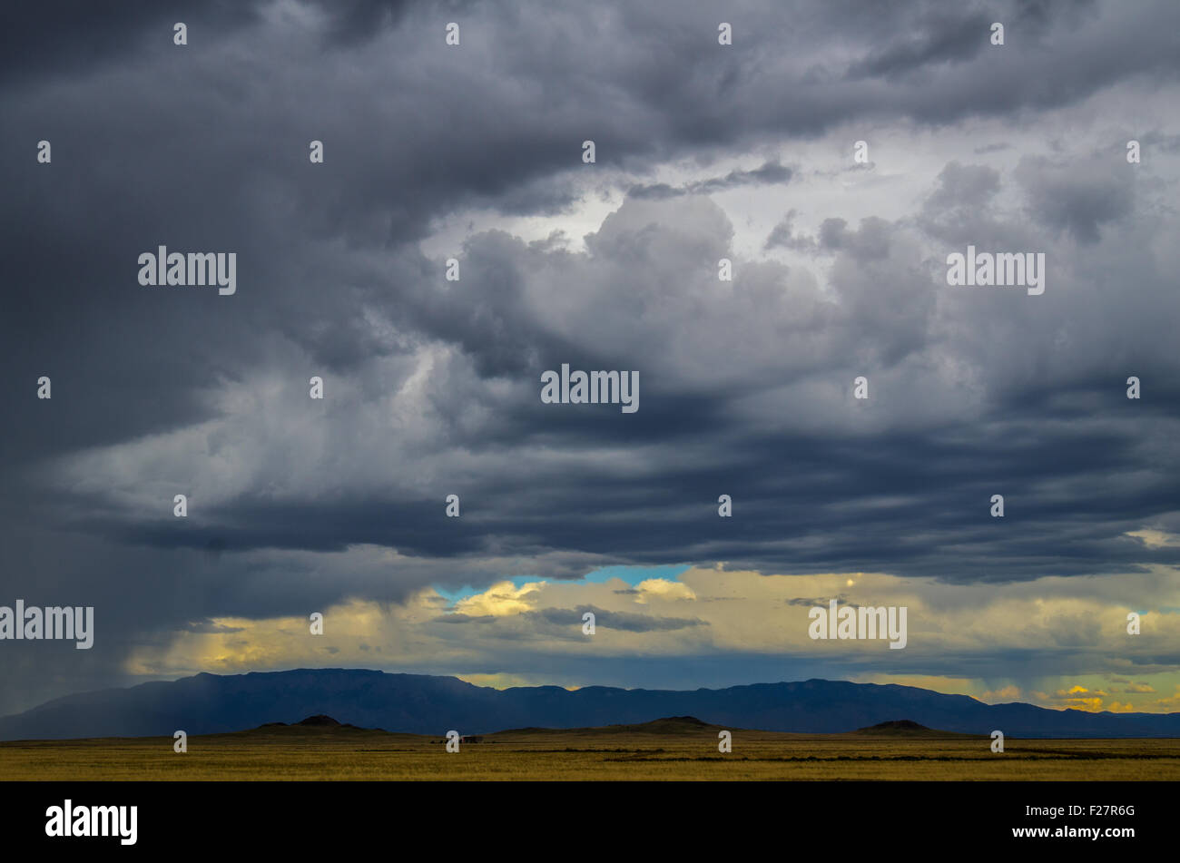 Monsoon storm over Albuquerque. Three Sisters volcanoes in foreground