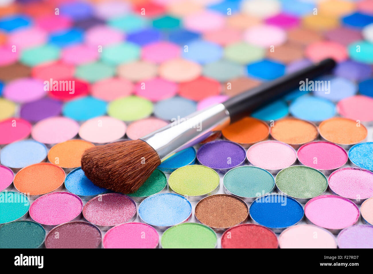 background with make-up brush and many multicolored eye shadows Stock Photo