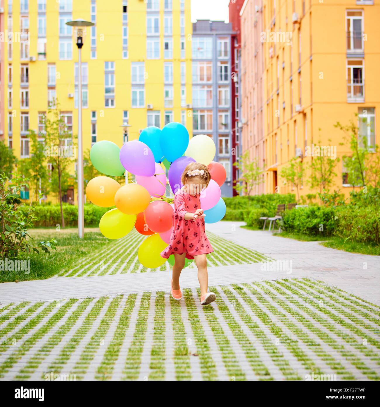 happy little girl outdoors with balloons Stock Photo - Alamy