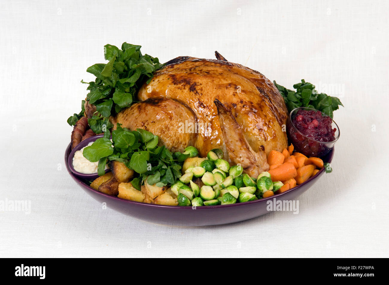 A Christmas roast turkey dinner with roast potatoes, chestnut stuffing, parsnips, cranberry sauce, bread sauce and vegetables.UK Stock Photo