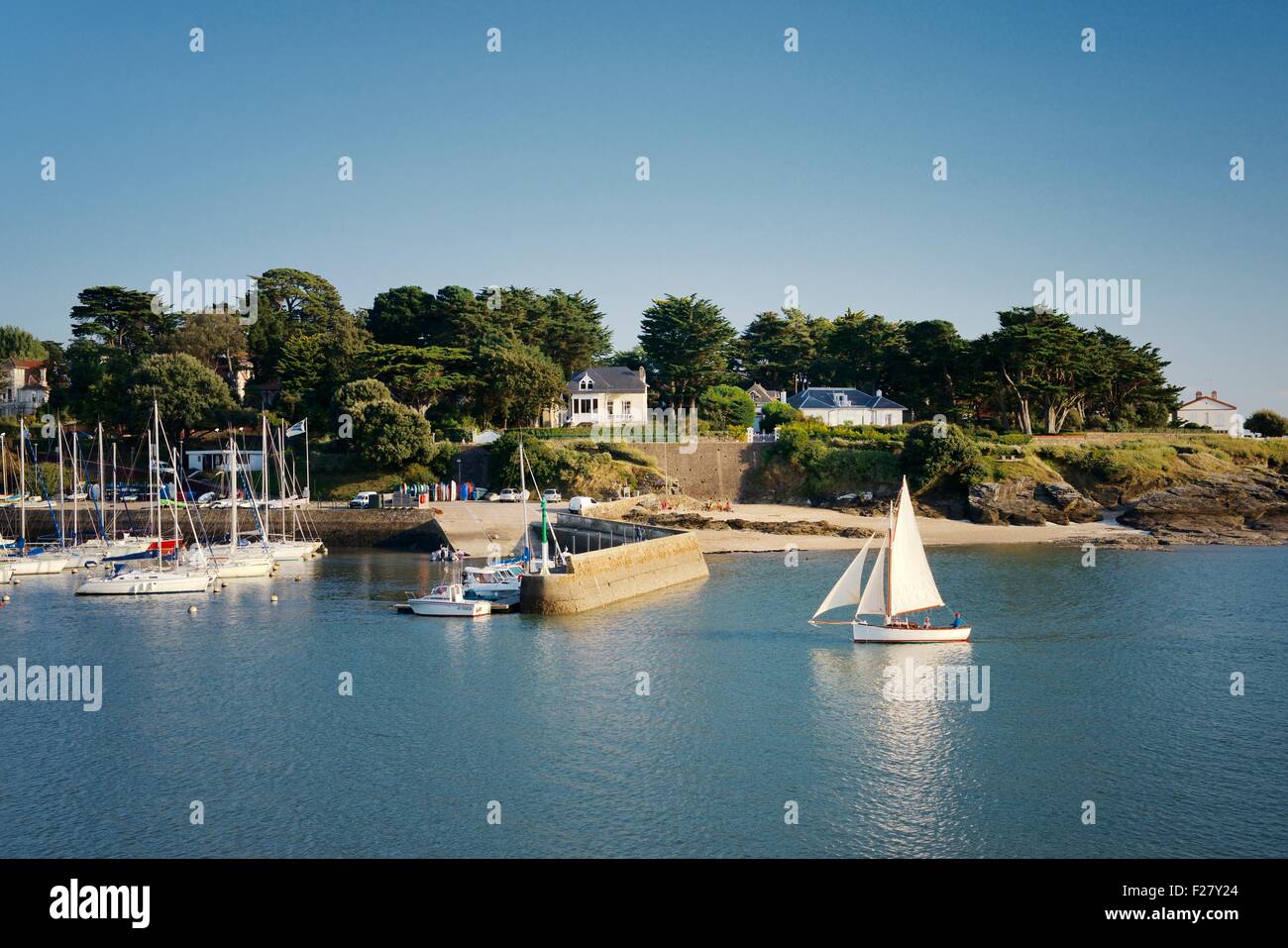 Sailing dinghy entering Gourmalon Port of Atlantic town of Pornic on the Jade Coast, Brittany, France. Summer Stock Photo