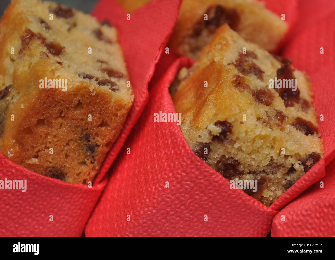 pieces of fruit cake wrapped in red serviettes Stock Photo