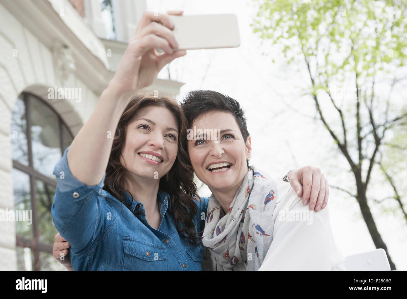Two friends make selfy in the sidewalk cafe, Bavaria, Germany Stock Photo
