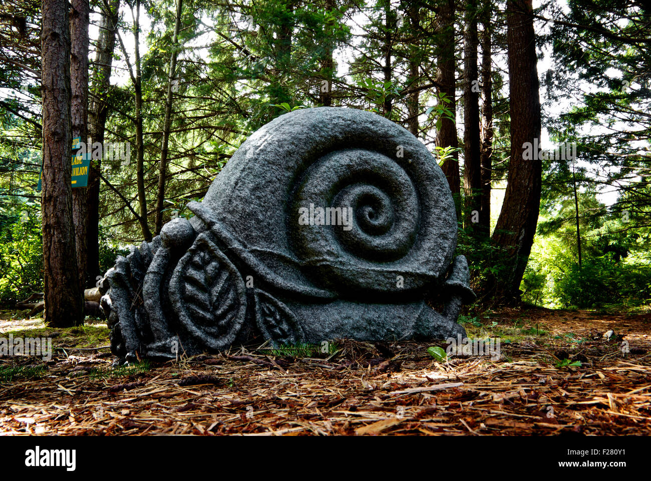 Granite snail sculpture Kitty Coleman Woodland Garden Artisan Festival Courtney BC Canada Stock Photo