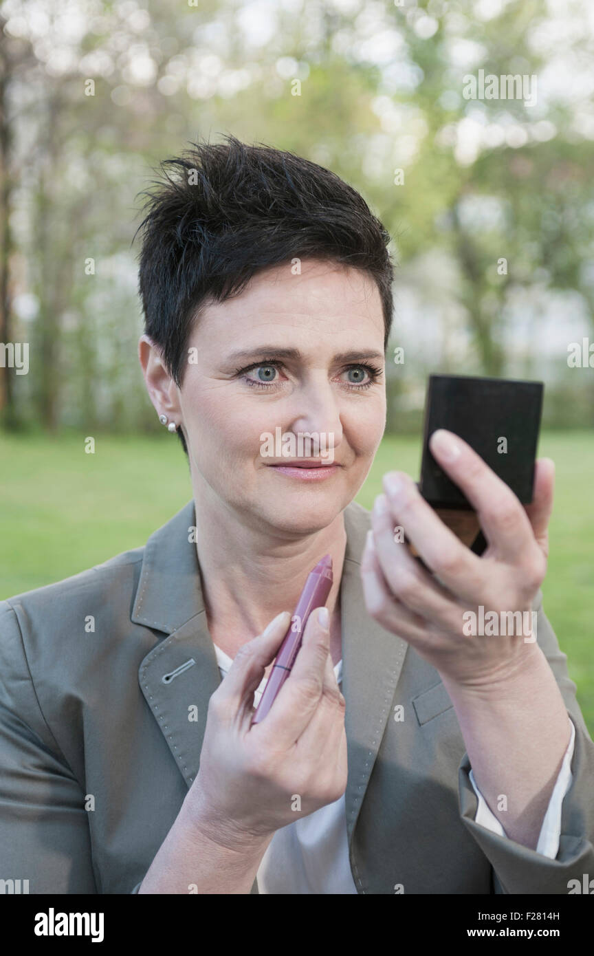Mature woman on park bench hi-res stock photography and images - Alamy