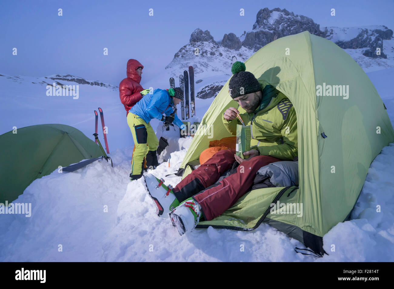 Men having dinner at bivouac camp, Tyrol, Austria Stock Photo