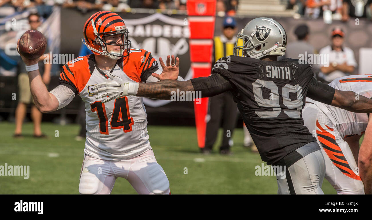 Oakland, California, USA. 13th Sep, 2015. Oakland Raider defensive end Aldon Smith (99) pressures Cincinnati Bengals quarterback Andy Dalton (14) to pass ball on Sunday, September 13, 2015, at O.co Coliseum in Oakland, California. The Bengals defeated the Raiders 33-13. Al Golub/CSM/Alamy Live News Stock Photo