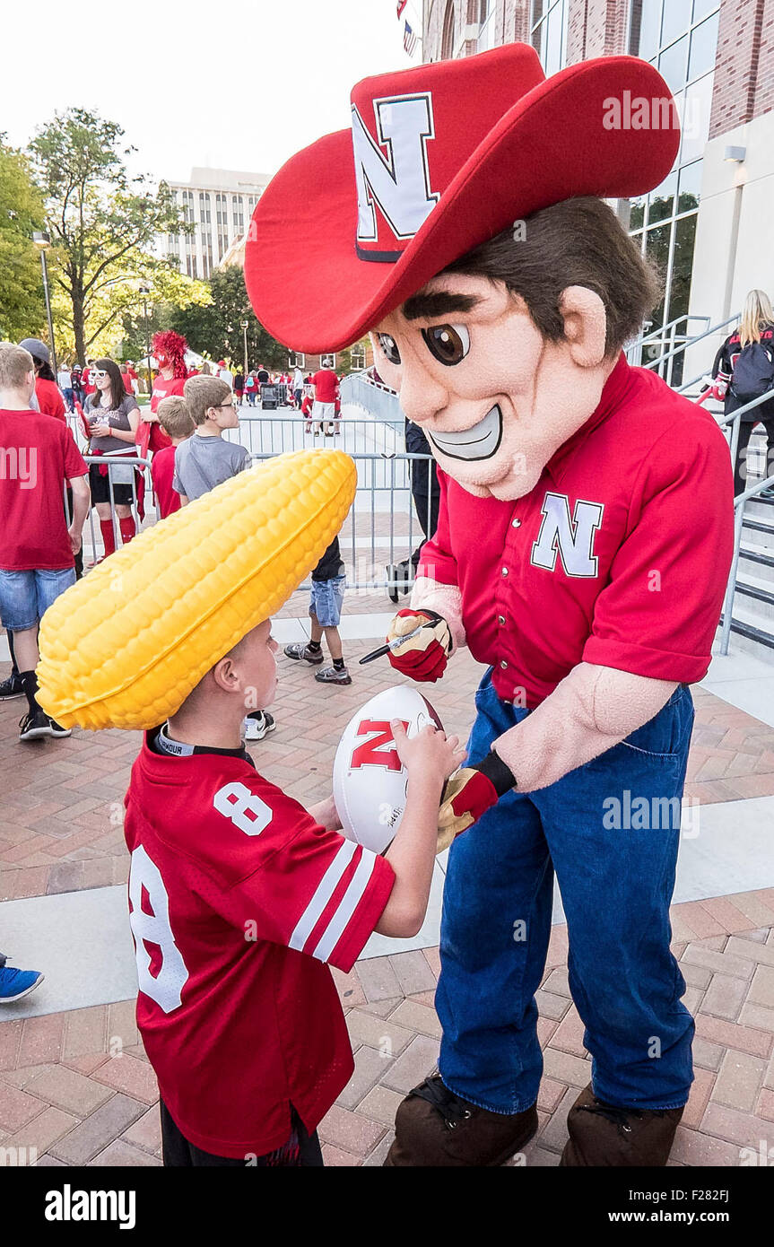 Lincoln, NE. USA. 12th Sep, 2015. Nebraska Cornhuskers mascot Herbie signs a football for a young fan before an NCAA Division 1 football game between the South Alabama Jaguars and Nebraska Cornhuskers at Memorial Stadium in Lincoln, NE.Attendance: 89,822.Nebraska won 48-9.Michael Spomer/Cal Sport Media. © csm/Alamy Live News Stock Photo