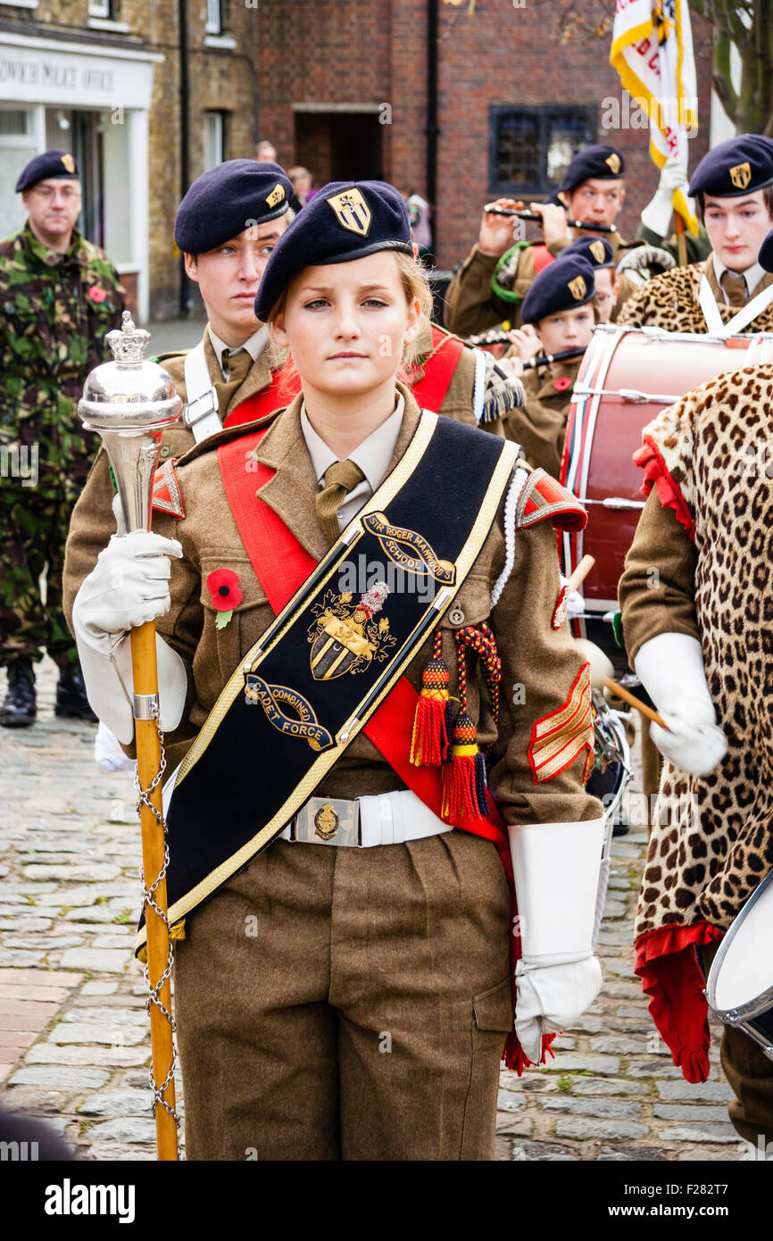 British Army youth cadet band lead by blonde female majorette at Remembrance Sunday parade. Close up of band formed in town square. Stock Photo