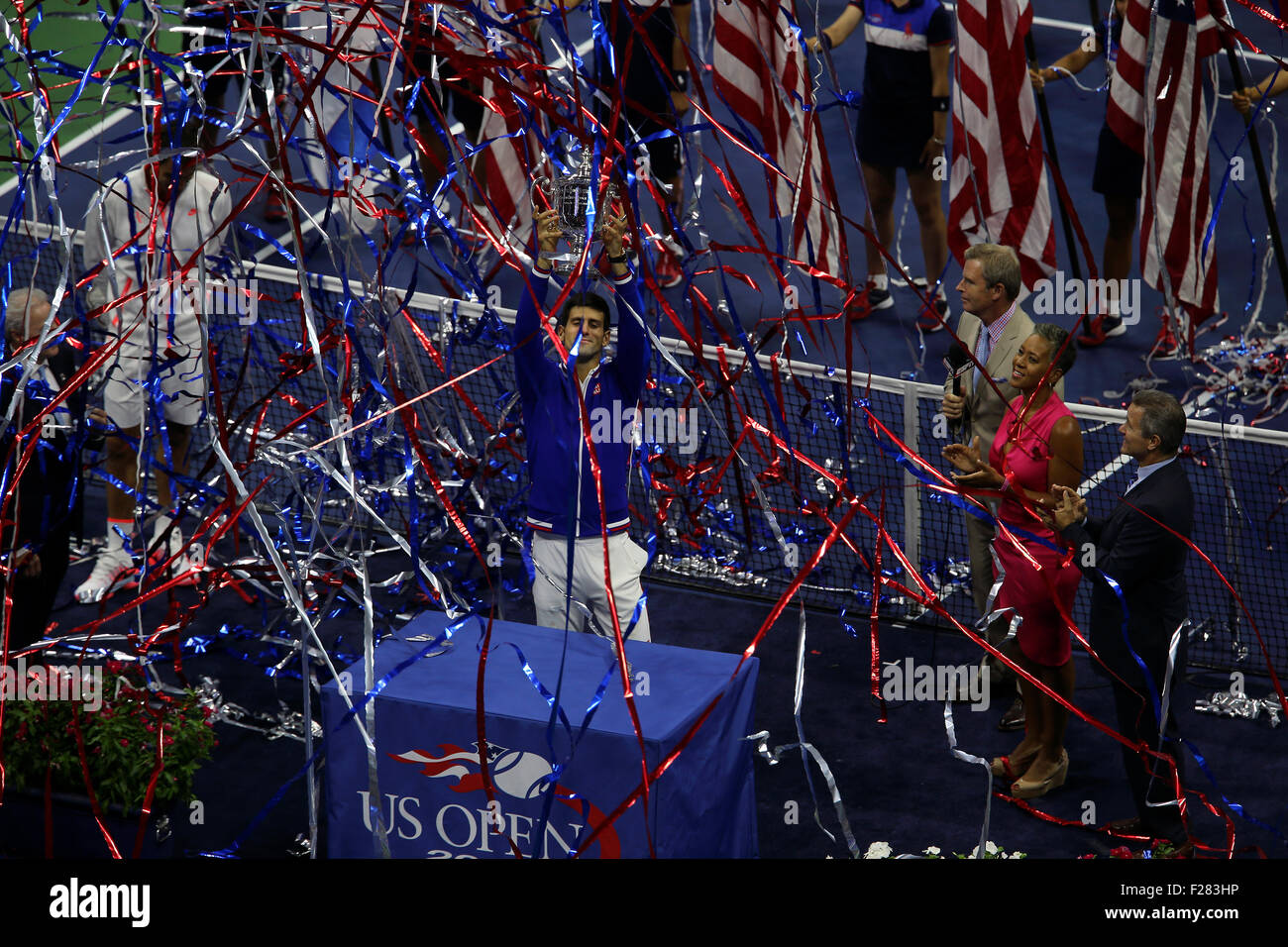 New York, USA. 13th Sep, 2015. Novak Djokovic of Serbia receives the U.S.  Open trophy as streamers fly through the air after Djokovic defeated Federer 6-4, 5-7, 6-4, 6-4 in the final of the U.S. Open at Flushing Meadows, New York on the afternoon of September 13th, 2015. Credit:  Adam Stoltman/Alamy Live News Stock Photo