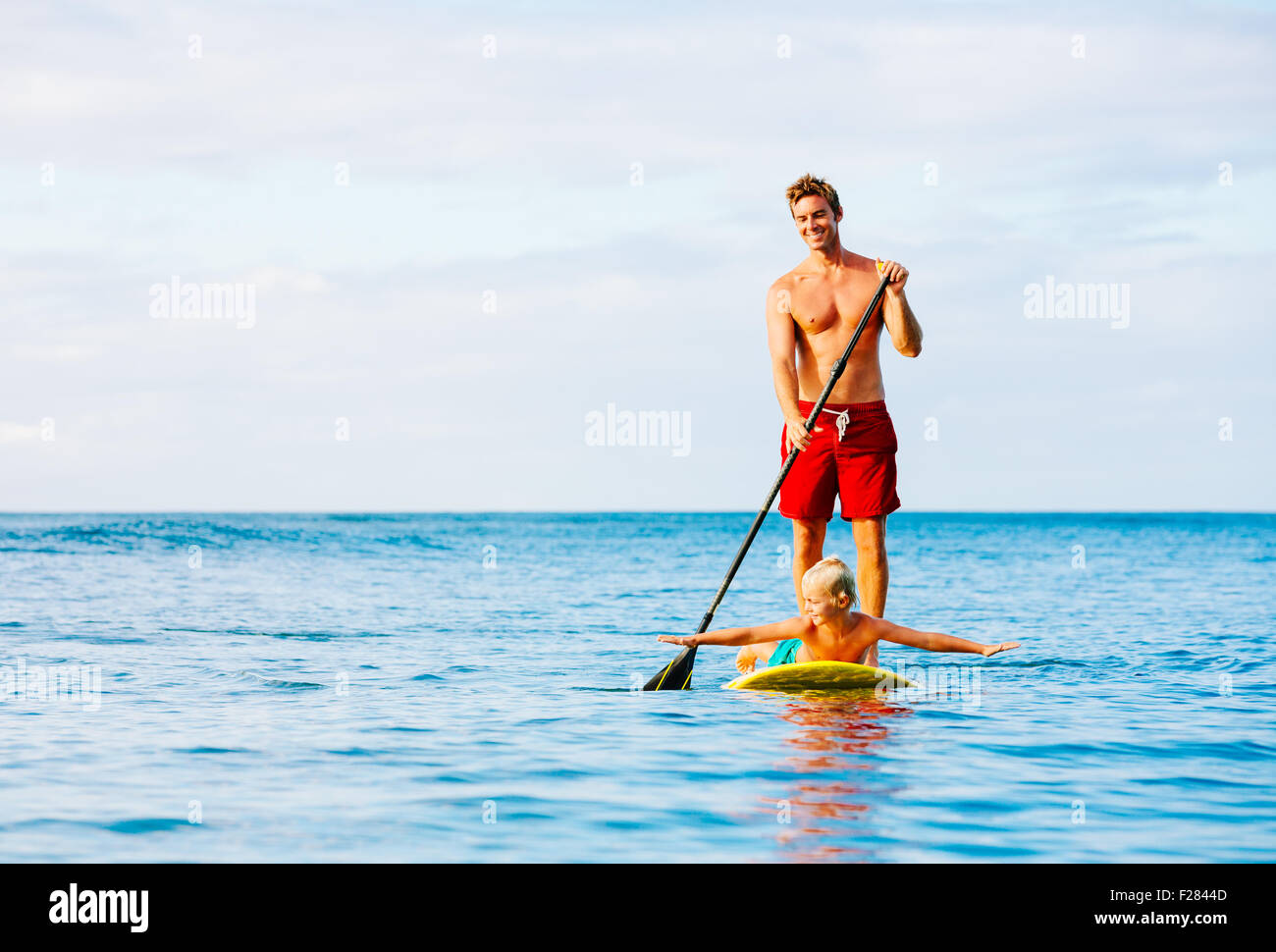 Father and Son Stand Up Paddling. Having Fun Outdoors. Summer Lifestyle. Stock Photo