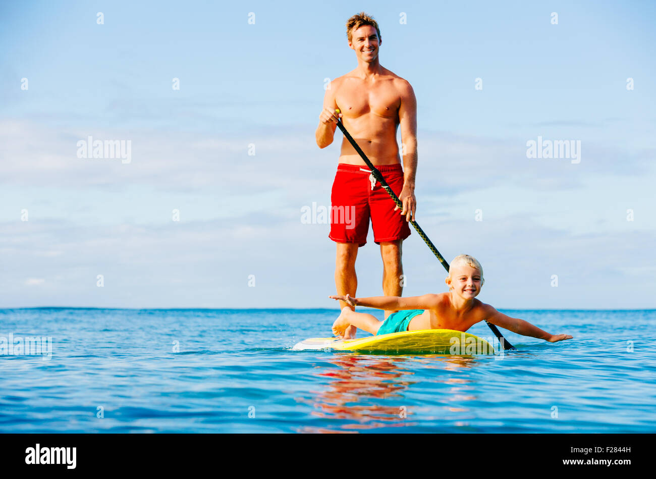 Father and Son Stand Up Paddling. Having Fun Outdoors. Summer Lifestyle. Stock Photo