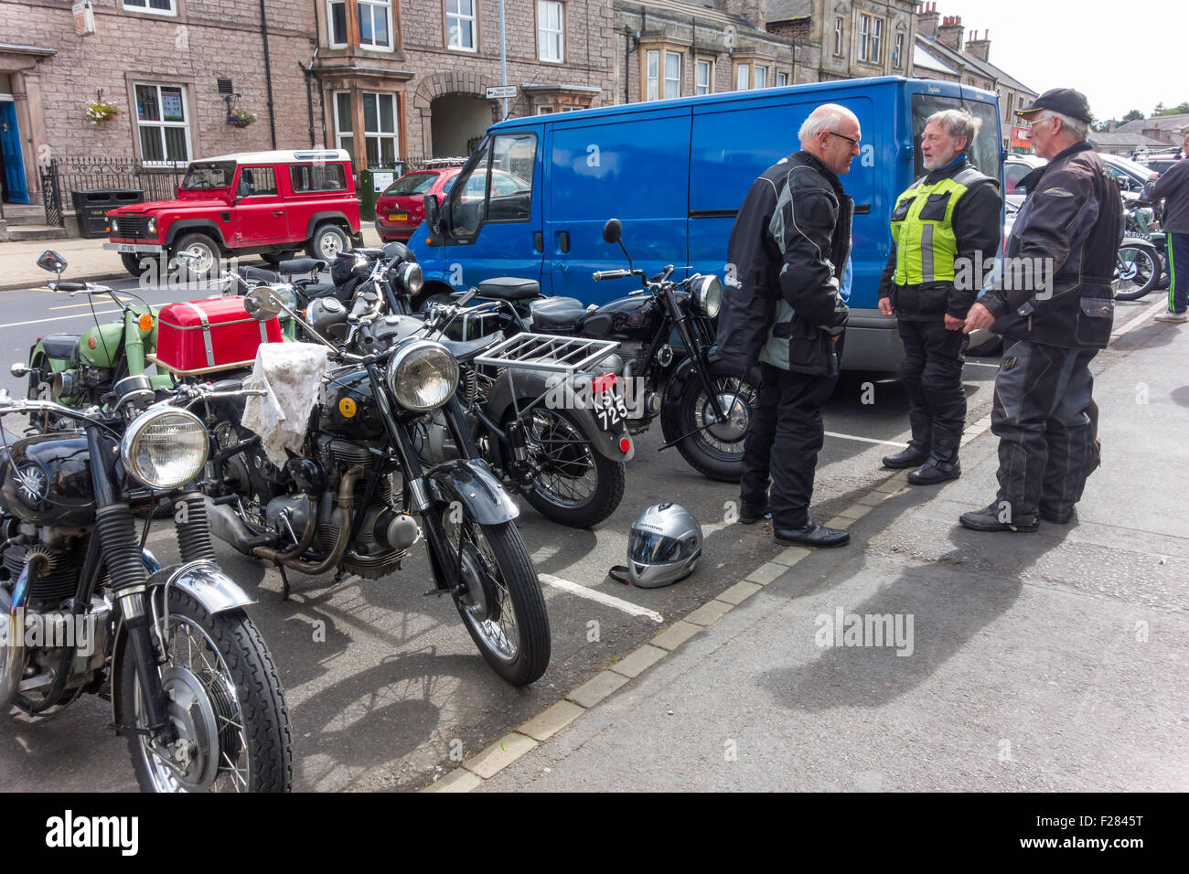 An group of enthusiasts with historic Sunbeam 500cc Motor Cycles in Kirkby Stephen Cumbria England UK Stock Photo