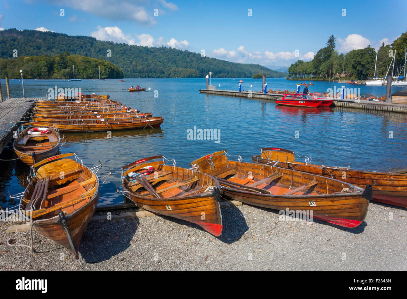 Autumn sunshine by the piers where traditional wooden skiffs may be hired Bowness Windermere Cumbria Stock Photo