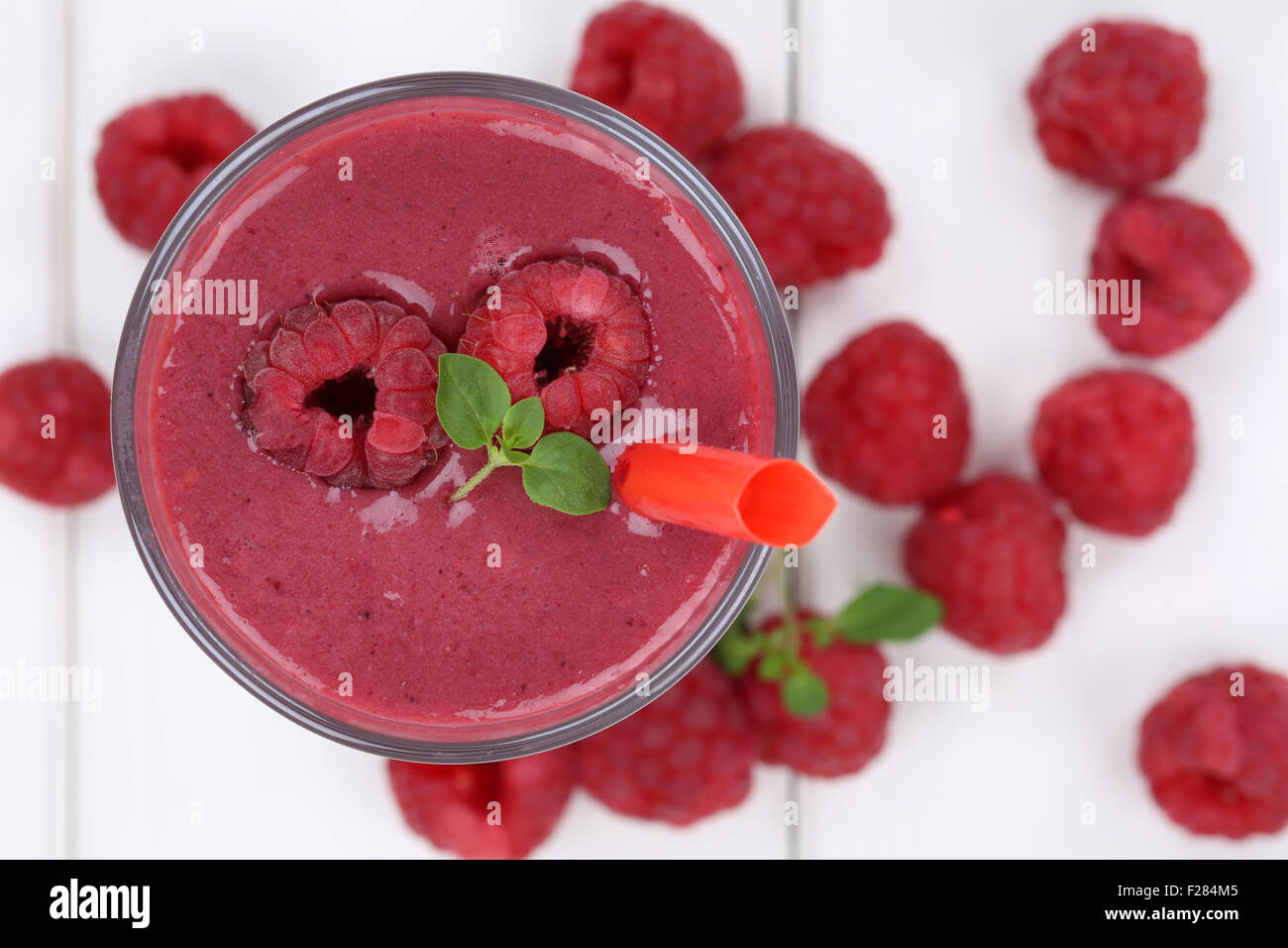 Raspberry smoothie fruit juice milkshake with raspberries fruits in summer from above Stock Photo