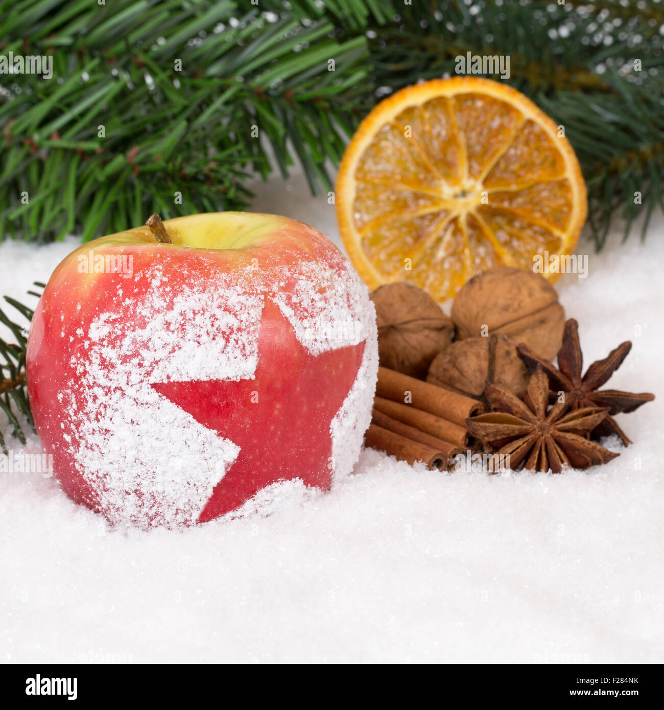 Winter apple fruit on Christmas decoration with snow and star Stock Photo