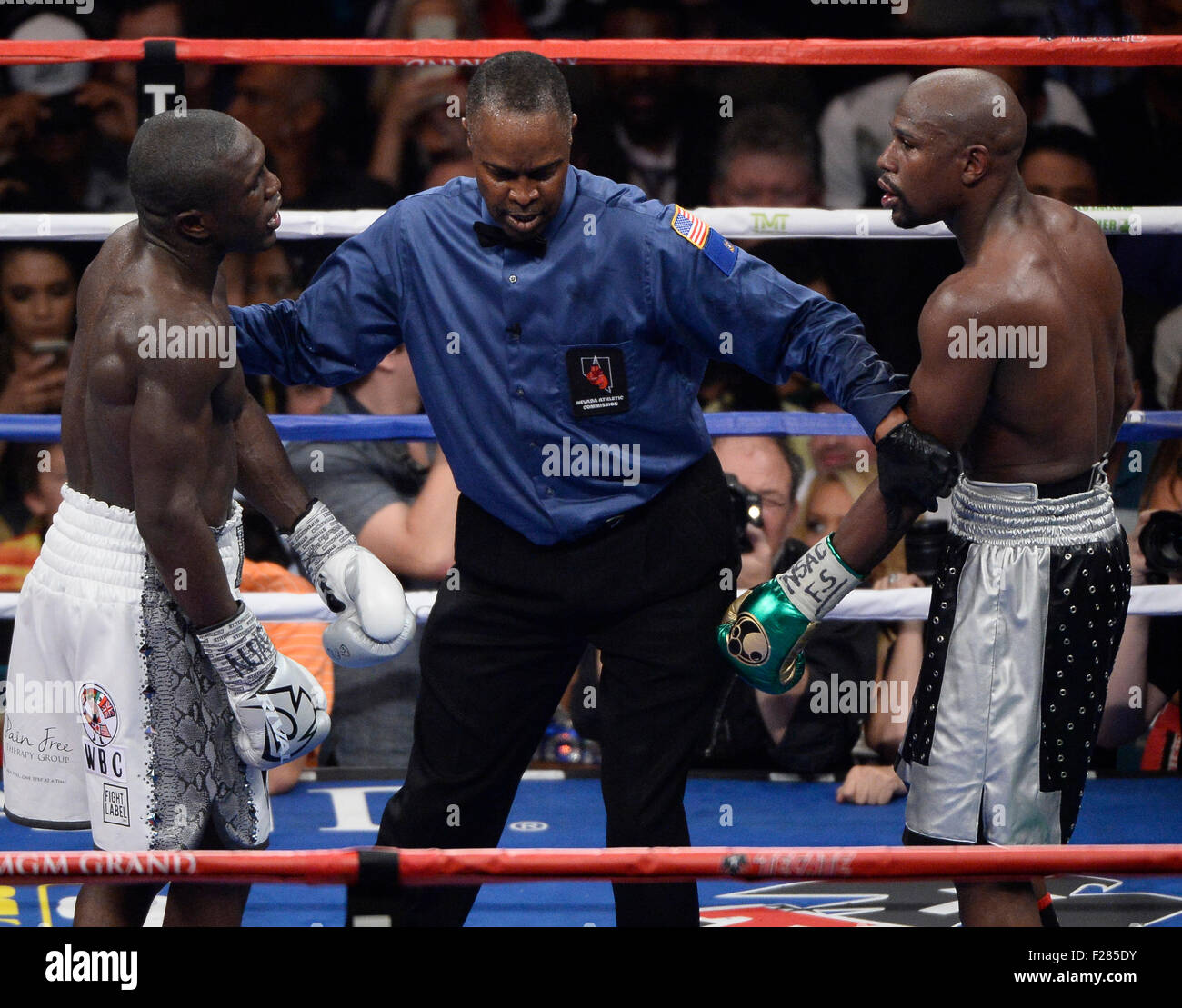 Las Vegas NV, USA. 12th Sep, 2015. (C) Referee Kenny Bayless gets in the middle of Floyd Mayweather Jr. and Andre Berto a they exchange words with each other Saturday at the MGM Grand Hotel. Floyd Mayweather Jr. took the win by Unanimous decision for the WBC&WBA world welterweight title. Floyd Mayweather Jr. has said that this will be his final fight of his 19yr career. Photo by: Gene Blevins/LA DailyNews/ZumaPress © Gene Blevins/ZUMA Wire/Alamy Live News Stock Photo