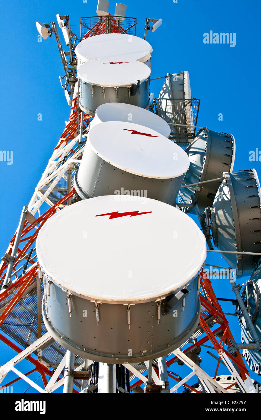 Modern cell and antenna with flat parabola on blue sky Stock Photo