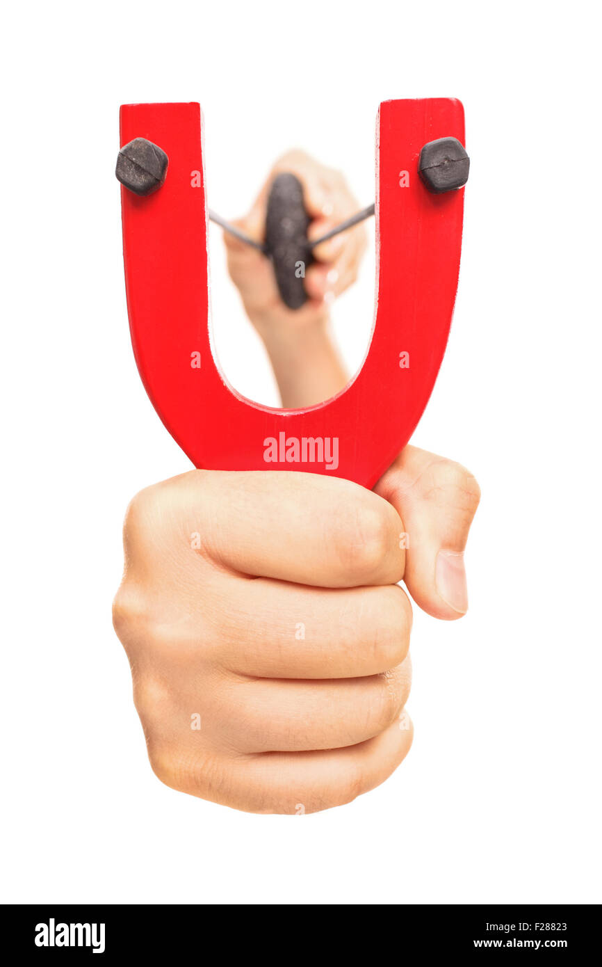Hand holding a stretched slingshot with a rock in it isolated on white background Stock Photo