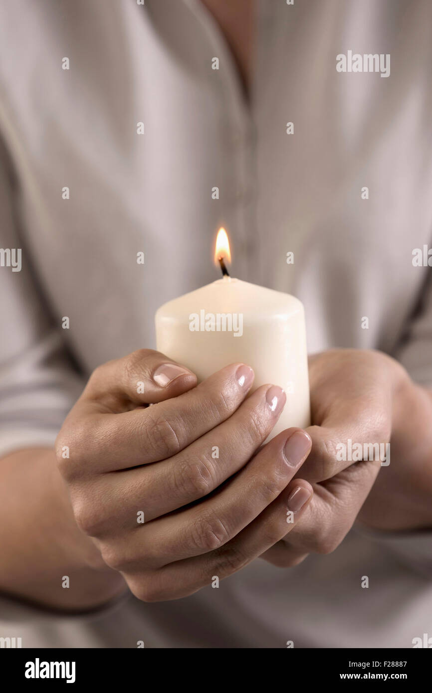 Holding burning candle in hand hires stock photography and images Alamy