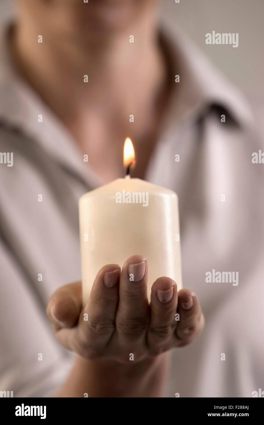 Woman holding burning candle in hand, Bavaria, Germany Stock Photo Alamy