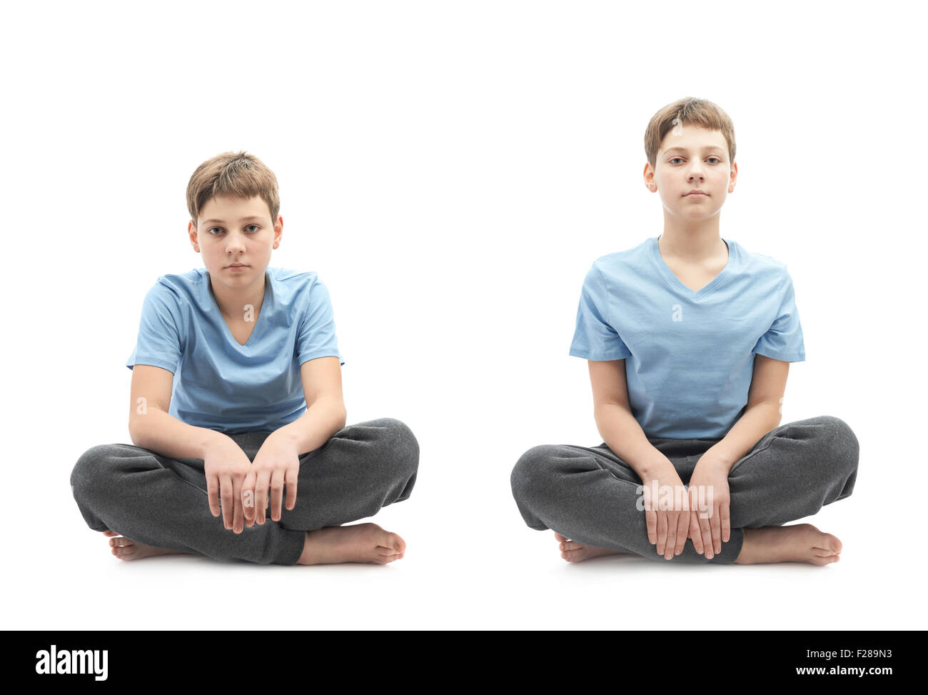 Caucasian 12 years old children boy in a blue t-shirt sitting in a lotus position, full shot composition isolated over the white Stock Photo