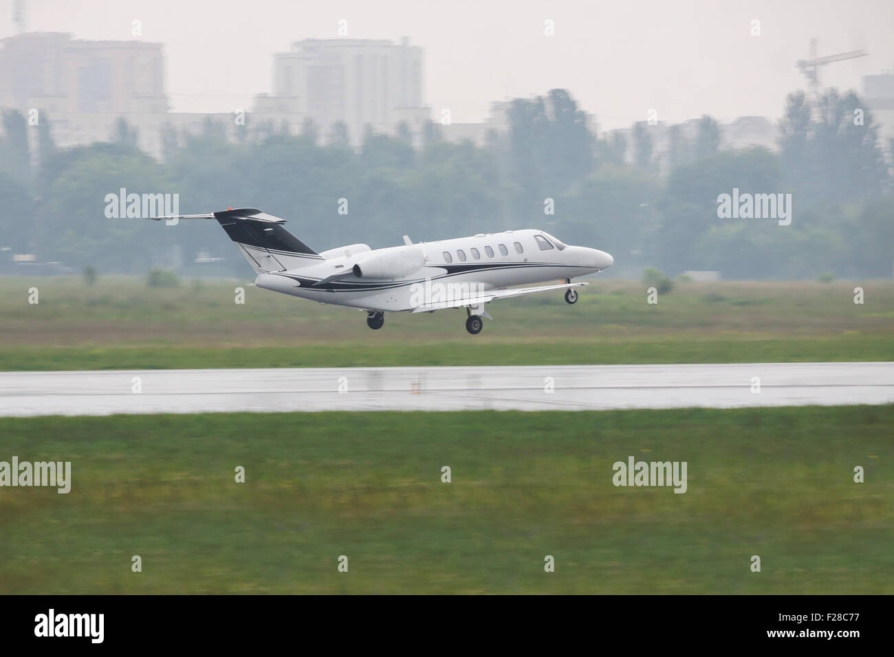 Private business jet plane is taking off under the rain Stock Photo Alamy