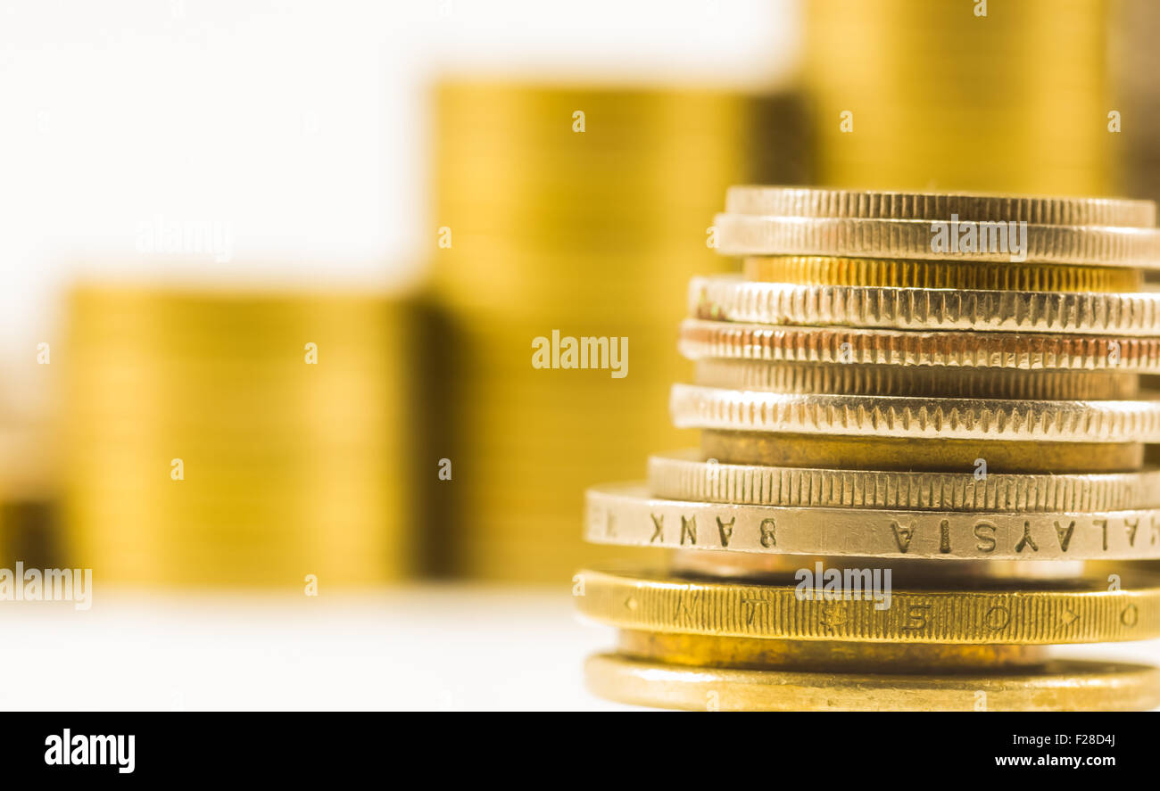 golden coins and coins stacked on each other in different positions Stock Photo