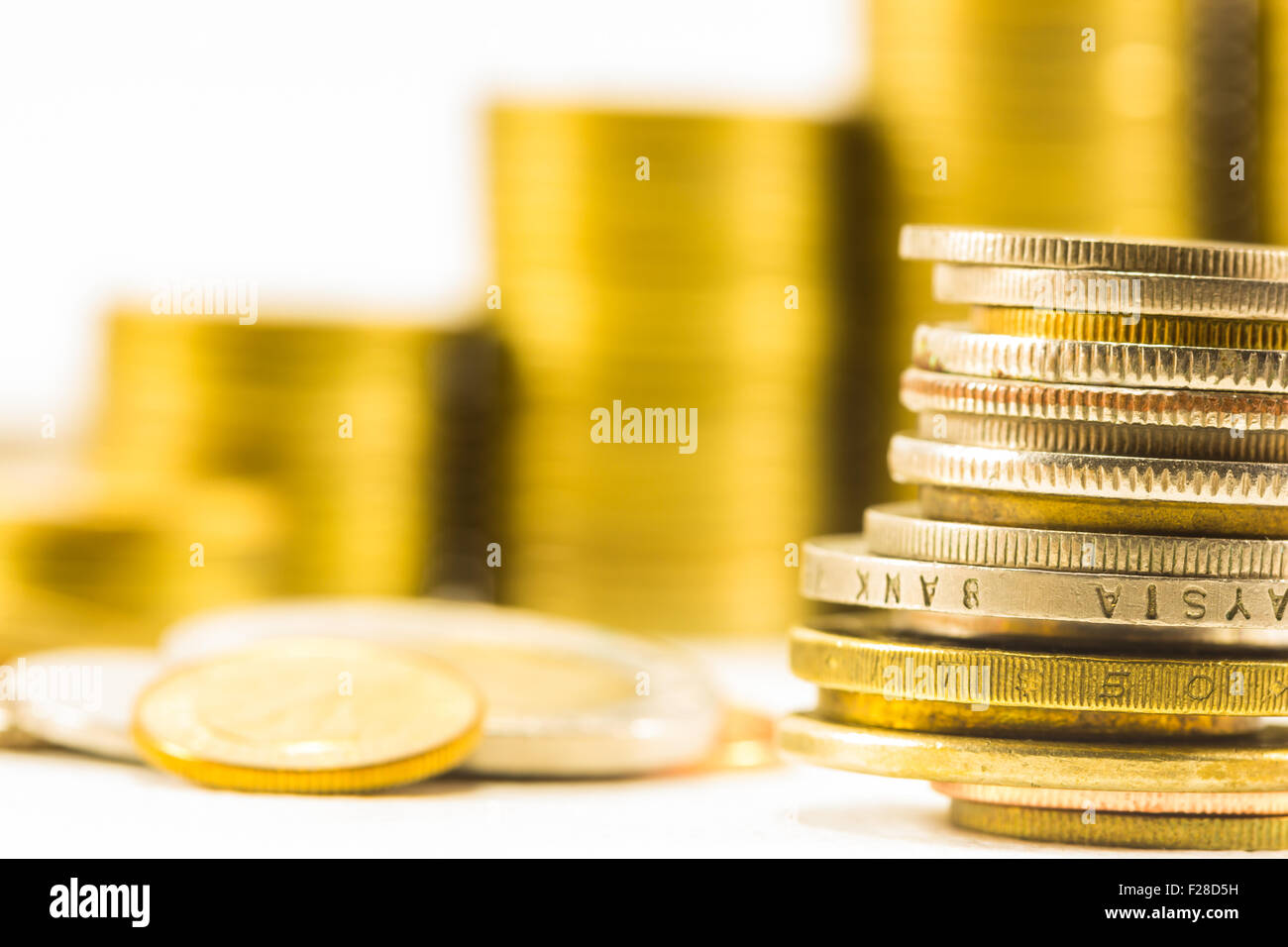 golden coins and coins stacked on each other in different positions Stock Photo