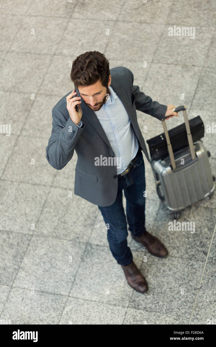 Modern casual business man on cell phone in hall airport. Top view Stock Photo