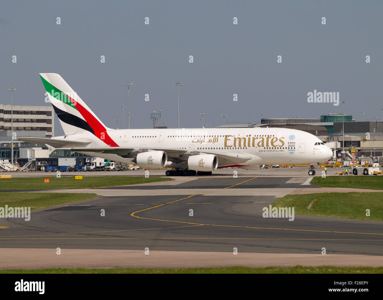 Emirates Airbus A380 double-decker passenger plane taxiing on Manchester Airport taxiway. Stock Photo