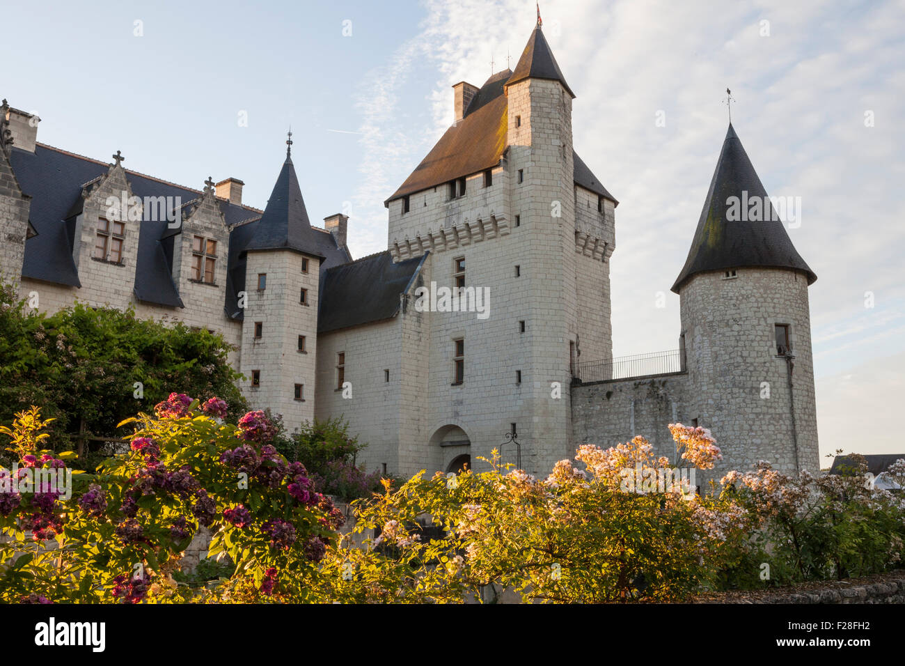 Early morning light on the Chateau du Rivau, with rose beds in foreground Stock Photo