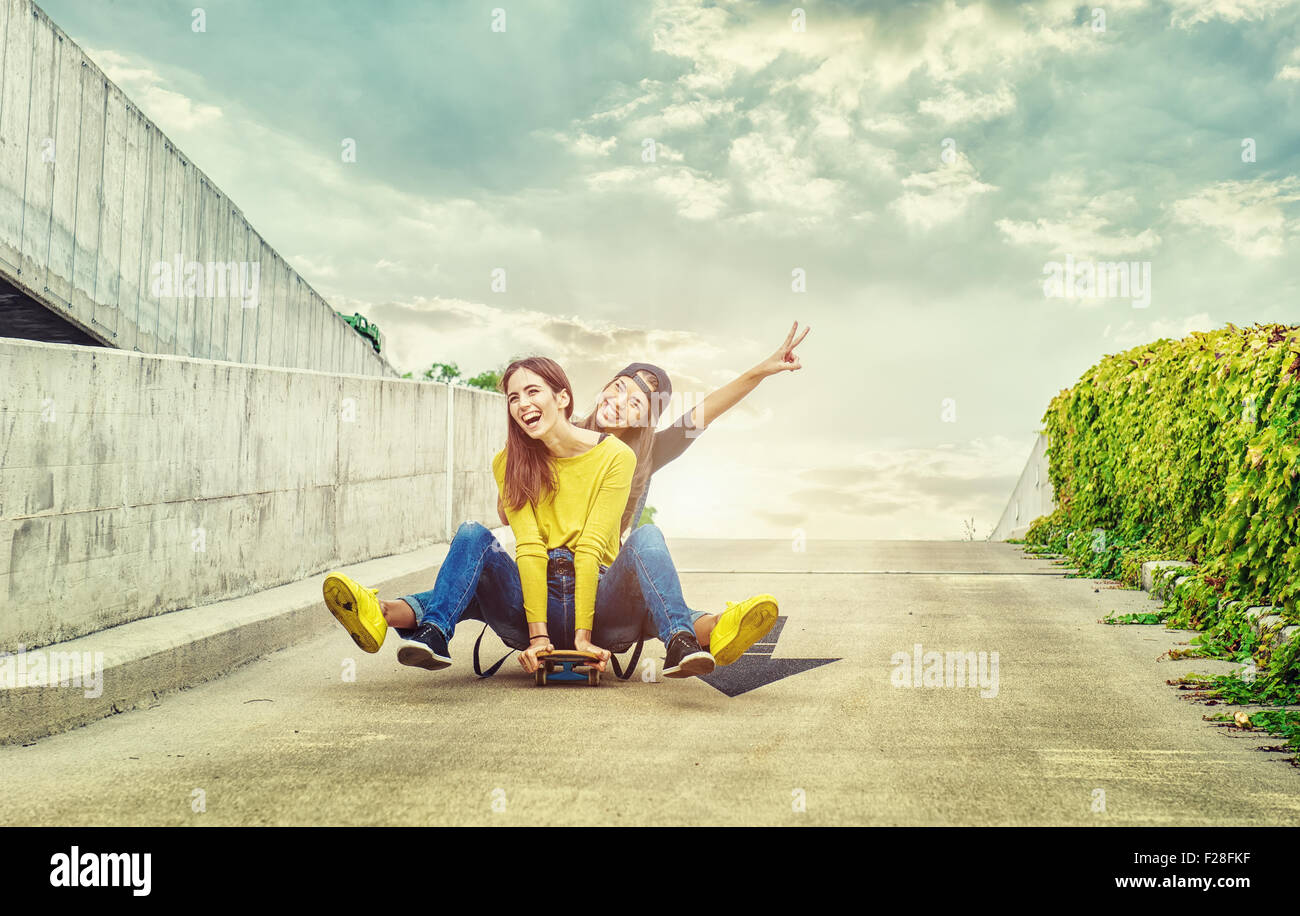 Skateboarder girlfriends roll down the slope Stock Photo