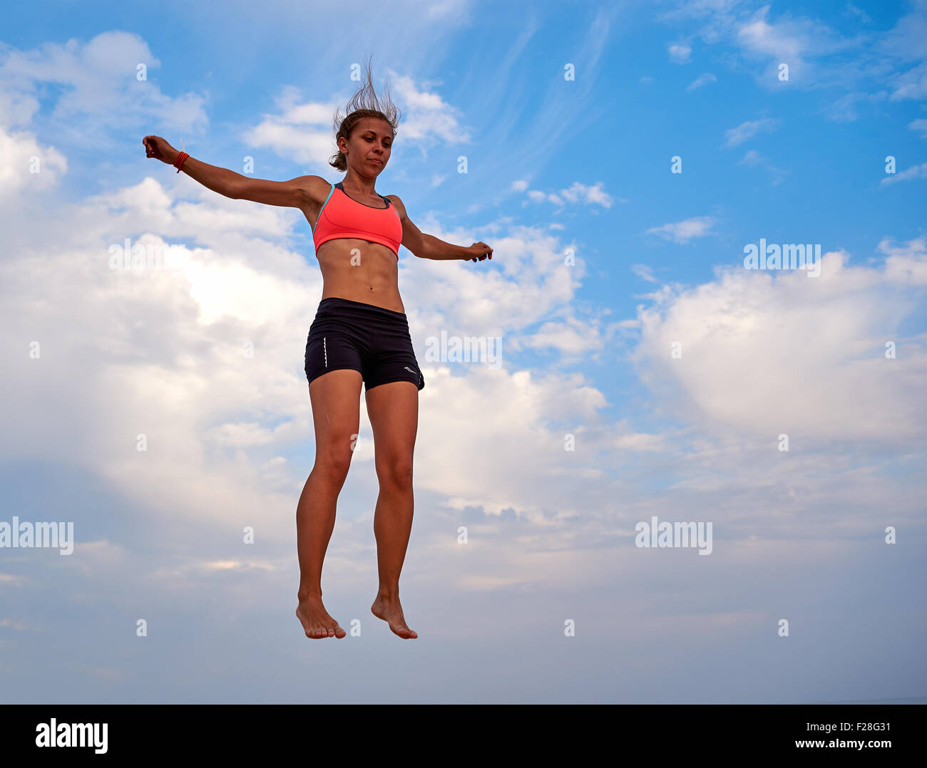 Flying girl over beautiful sky Stock Photo