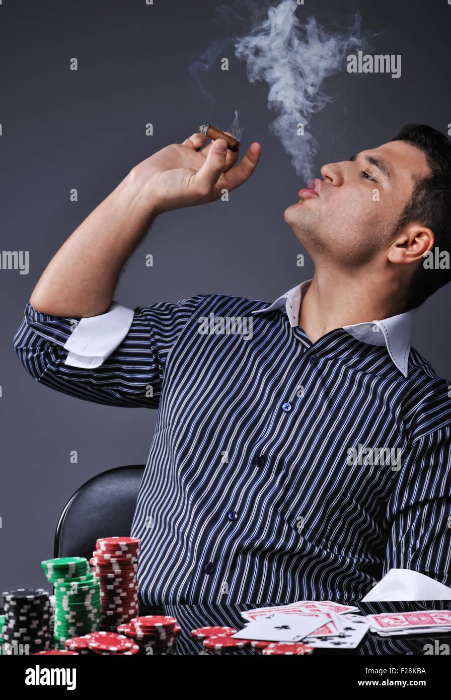 Portrait of a young gangster smoking and playing poker Stock Photo Alamy