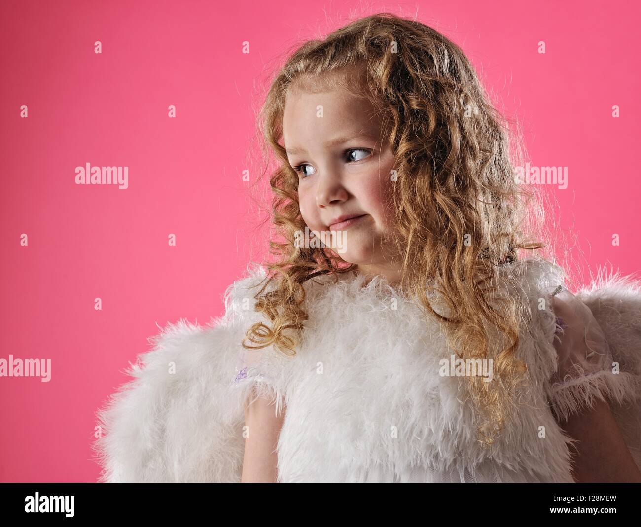 Beautiful little angel girl isolated on pink background Stock Photo - Alamy
