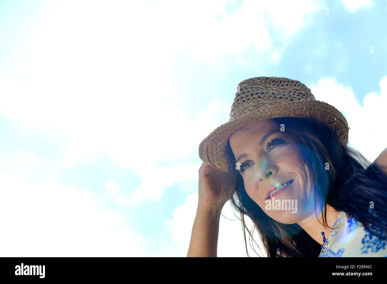 Portrait of a woman wearing a sun hat Stock Photo - Alamy