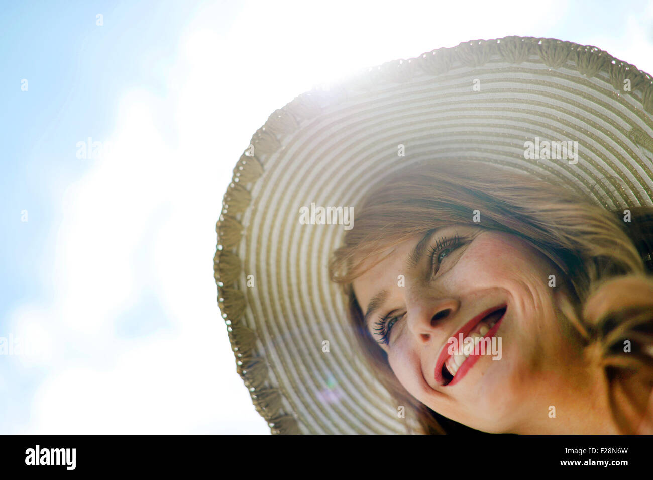 Portrait of a woman wearing a sun hat Stock Photo - Alamy