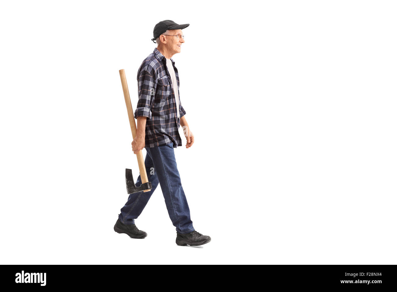 Full length profile shot of a senior man holding an ax and walking isolated on white background Stock Photo