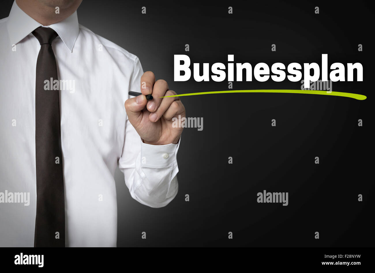 Business Plan is written by businessman background concept. Stock Photo